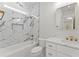 Elegant bathroom featuring marble tiled walls, a soaking tub, and a vanity with marble countertops and modern gold hardware at 1540 Brooks S Rd, Lawrenceville, GA 30045