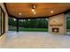 Covered patio featuring a brick fireplace, wooden ceiling, and wooded view at 1540 Brooks S Rd, Lawrenceville, GA 30045