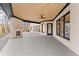 Spacious covered patio with a stone fireplace, wood ceiling, and multiple windows with backyard views at 1540 Brooks S Rd, Lawrenceville, GA 30045