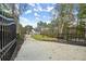 View of home at the end of a long driveway with gated entry, featuring a well-manicured lawn at 1540 Brooks S Rd, Lawrenceville, GA 30045
