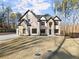 Beautiful two-story home with stone accents and a modern garage door at 1540 Brooks S Rd, Lawrenceville, GA 30045