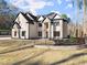 Stunning two-story home with a stone archway and modern black window frames at 1540 Brooks S Rd, Lawrenceville, GA 30045