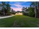 Twilight view from yard to house, long driveway leading up to a modern two-story home at 1540 Brooks S Rd, Lawrenceville, GA 30045