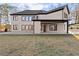 Back of home featuring a covered patio and a sizable lawn area at 1540 Brooks S Rd, Lawrenceville, GA 30045