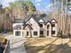 Two-story home featuring a modern garage door and stone accents at 1540 Brooks S Rd, Lawrenceville, GA 30045