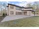 Rear exterior view of home with a large patio area and expansive lawn at 1540 Brooks S Rd, Lawrenceville, GA 30045