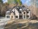 Beautiful two-story home featuring a modern garage door and stone accents at 1540 Brooks S Rd, Lawrenceville, GA 30045