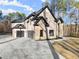 Two-story home featuring a modern garage door and stone accents at 1540 Brooks S Rd, Lawrenceville, GA 30045