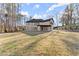 Back of the house with a large lawn, patio and lots of windows for natural light at 1540 Brooks S Rd, Lawrenceville, GA 30045
