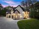 Grand two-story home featuring a three-car garage and a spacious driveway at 1540 Brooks S Rd, Lawrenceville, GA 30045