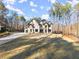 Spacious two-story home with manicured lawn and garden at twilight at 1540 Brooks S Rd, Lawrenceville, GA 30045