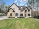 A two-story modern home with a large front yard and stone accents at 1540 Brooks S Rd, Lawrenceville, GA 30045