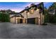 Side exterior view of home featuring a spacious garage with modern black doors and ample parking at 1540 Brooks S Rd, Lawrenceville, GA 30045