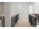 Hallway with dark metal railings and wooden handrails, leading to bright rooms at 1540 Brooks S Rd, Lawrenceville, GA 30045