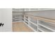 Spacious walk-in pantry with custom white shelving and cabinets, butcher block countertops, and light wood floors at 1540 Brooks S Rd, Lawrenceville, GA 30045