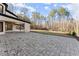 Spacious stone patio leading to a large backyard and wooded area at 1540 Brooks S Rd, Lawrenceville, GA 30045