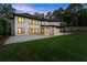The light brick home features a covered patio, a manicured lawn and is lined with well-trimmed shrubbery at 1540 Brooks S Rd, Lawrenceville, GA 30045