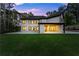 The rear exterior of this stunning, modern home features many windows and a pristine backyard lawn at 1540 Brooks S Rd, Lawrenceville, GA 30045