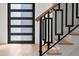 Modern staircase with wood treads and custom metal railing near a glass door at 1540 Brooks S Rd, Lawrenceville, GA 30045