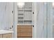 Elegant walk-in closet featuring custom shelving, drawers, and a sparkling chandelier at 1540 Brooks S Rd, Lawrenceville, GA 30045