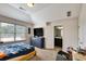 Bedroom with a TV, blue accents, and natural light coming in from a large window at 1993 Side Branch Way, Lawrenceville, GA 30045