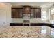 Gourmet kitchen featuring granite countertops, stainless steel appliances, and custom cabinetry at 1993 Side Branch Way, Lawrenceville, GA 30045