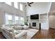 Bright living room with high ceilings, a stone fireplace, built-in shelving, and large windows at 1993 Side Branch Way, Lawrenceville, GA 30045