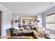 Cozy living room with a large couch, view of the kitchen, hardwood floors, and a window at 1993 Side Branch Way, Lawrenceville, GA 30045