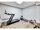 Home workout area with a treadmill, yoga mat, dumbbells, and wooden flooring at 1993 Side Branch Way, Lawrenceville, GA 30045