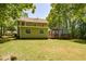 Wide backyard view showing a two-story home, wooden deck and mature landscaping at 605 Sutton Sw Way, Marietta, GA 30064