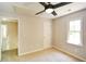 Cozy carpeted bedroom featuring a ceiling fan and a bright window at 605 Sutton Sw Way, Marietta, GA 30064
