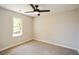 Neutral bedroom featuring a ceiling fan, carpet, and a bright window at 605 Sutton Sw Way, Marietta, GA 30064