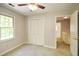 Neutral bedroom with closet, ceiling fan, carpet, and natural light at 605 Sutton Sw Way, Marietta, GA 30064