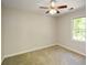 Neutral bedroom featuring a ceiling fan, carpet, and a bright window at 605 Sutton Sw Way, Marietta, GA 30064