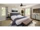 Serene bedroom with a gray upholstered bed frame, neutral decor, and ample natural light from multiple windows at 605 Sutton Sw Way, Marietta, GA 30064