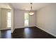 Bright dining room with modern chandelier and hardwood floors, perfect for entertaining guests at 605 Sutton Sw Way, Marietta, GA 30064