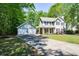 View of a two-story house and two-car garage, set back from the street with a long driveway at 605 Sutton Sw Way, Marietta, GA 30064