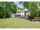 Two-story house featuring a well-maintained lawn and a gray exterior, complemented by dark shutters and a two-car garage at 605 Sutton Sw Way, Marietta, GA 30064