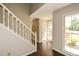 Bright foyer with dark wood floors, staircase, and natural light streaming through a window at 605 Sutton Sw Way, Marietta, GA 30064