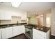 Bright kitchen featuring white cabinets, stainless steel appliances, and a breakfast bar overlooking the living area at 605 Sutton Sw Way, Marietta, GA 30064