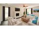 Bright living room featuring a fireplace, ceiling fan, and comfortable seating area with plush sofas at 605 Sutton Sw Way, Marietta, GA 30064