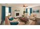 Cozy living room with fireplace, plush seating, and bright turquoise accents at 605 Sutton Sw Way, Marietta, GA 30064