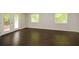 Spacious living room with hardwood floors, double doors to the patio, and lots of natural light at 605 Sutton Sw Way, Marietta, GA 30064