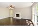 Bright living room featuring hardwood floors, a ceiling fan, and a brick fireplace at 605 Sutton Sw Way, Marietta, GA 30064
