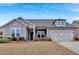 Attractive single-Gathering home with a two-car garage, complemented by well-maintained landscaping and a clear sky at 242 Cordova St, Woodstock, GA 30189