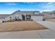 Charming single-Gathering home with attached two-car garage and manicured lawn under a bright blue sky at 242 Cordova St, Woodstock, GA 30189