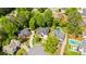 Aerial view of a home with a pool surrounded by lush greenery in a residential neighborhood at 3105 Birchton St, Johns Creek, GA 30022