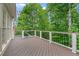 Wooden deck with white railings overlooking lush greenery and mature trees at 3105 Birchton St, Johns Creek, GA 30022