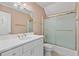 Bathroom with a white vanity, framed mirror, and a shower/tub with a sliding glass door at 3105 Birchton St, Johns Creek, GA 30022