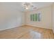 This bedroom has hardwood floors, a ceiling fan, and natural light from the window at 3105 Birchton St, Johns Creek, GA 30022